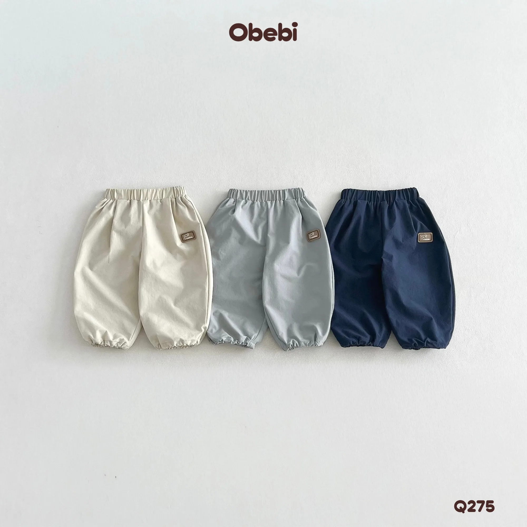 Q275 – Quần Gió Dài Trẻ Em Thu Đông Gắn Tag Cao Su Obebi