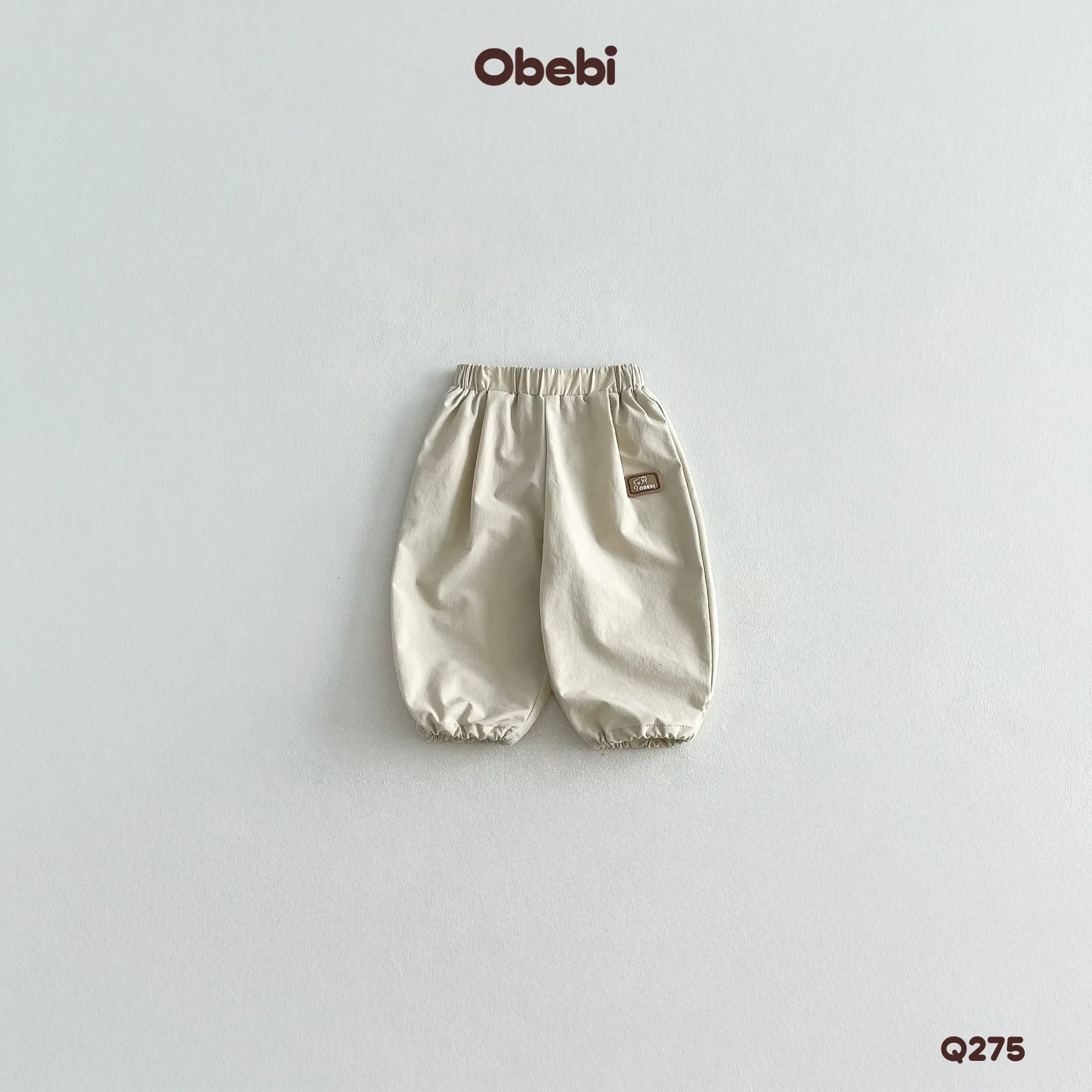 Q275 – Quần Gió Dài Trẻ Em Thu Đông Gắn Tag Cao Su Obebi