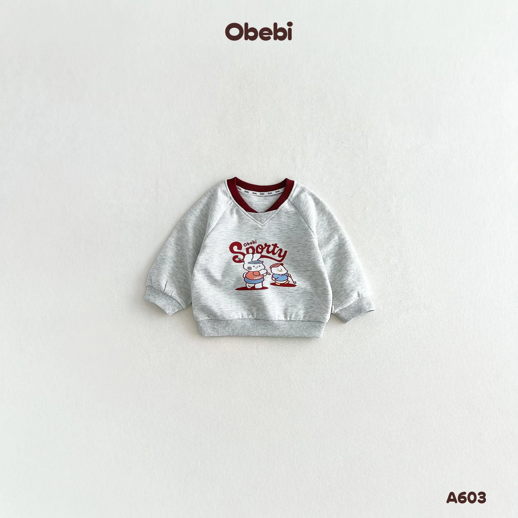 A603 – Áo Dài Tay Raglan Trẻ Em Thu Đông Cổ Tim Hình In Nhân Vật Thương Hiệu Obebi